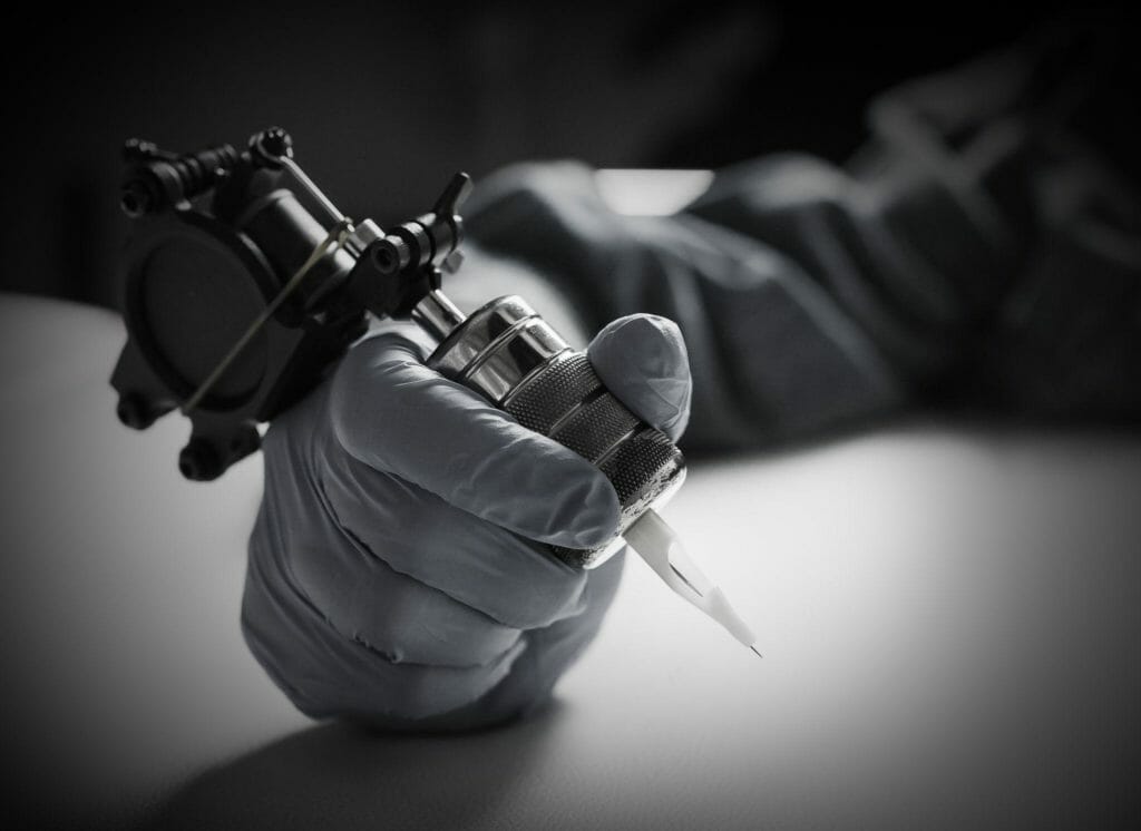 Tattoo artist holding tattoo machine, machine for a tattoo concept
